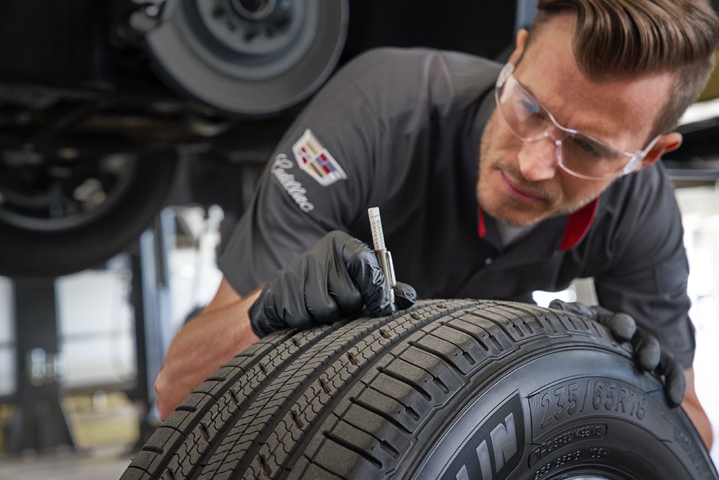 Cadillac Protection Expert Checking Tire